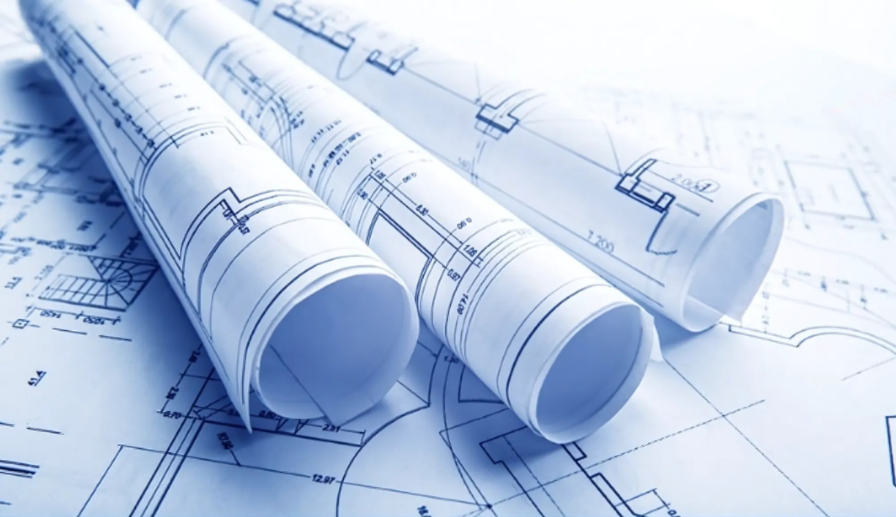 Rolled architectural blueprints illustrating commercial and industrial refrigeration system planning and workflow in Southern New England.